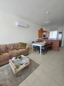 a living room with a couch and a table at Quiet 61 Perivolia in Meneou