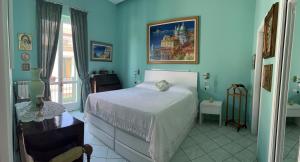 a bedroom with a bed and a painting on the wall at The Rooftop Terrace b&b Two Double Rooms with private bathrooms and an equipped roof terrace in Sant'Agnello
