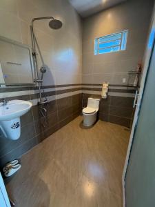 a bathroom with a toilet and a sink at Phong Tom Retreat - Pet friendly location in Long Khanh +26 photos