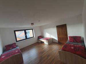 an empty room with two beds and a window at Pension Heller in Odelzhausen