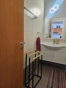 a bathroom with a sink and a mirror and a door at Quiet 61 Perivolia in Meneou +12 photos