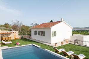 a villa with a swimming pool and a house at Casa Sorelle secluded villa with breathtaking pool in Seline