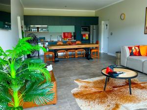 a living room with a couch and a table at Number 1 at SuPaViews in Wilderness