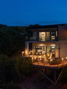 a house with lights on the side of it at night at Number 1 at SuPaViews in Wilderness