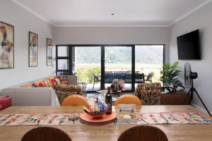 a living room with a wooden table and chairs at Number 1 at SuPaViews in Wilderness