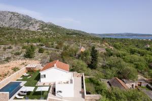 an aerial view of a house with a swimming pool at Casa Sorelle secluded villa with breathtaking pool in Seline