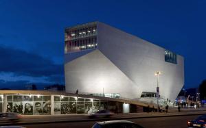 a building at night with cars in front of it at My Home in OPorto in Maia