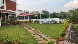 a garden with a soccer field and a goal at Nisarg Forever Resort in Jāmb