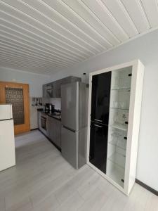 a kitchen with stainless steel appliances and a large refrigerator at Ferienwohnung Tanja in Winterberg