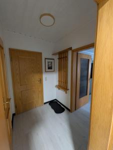 a room with two wooden doors and a room with a floor at Ferienwohnung Tanja in Winterberg