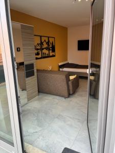a living room with a couch and a television at Quartier 8 - Ein-Zimmer-Apartment in Geisenfeld +3 photos