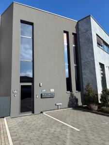 a large building with a large glass door at Quartier 8 - Ein-Zimmer-Apartment in Geisenfeld
