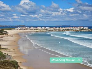 a view of a beach with houses and the ocean at Maia Surf House - Baleal in Ferrel