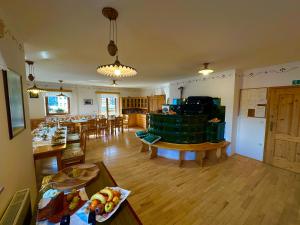 a living room with a table and a dining room at Kmetija Matk in Solčava
