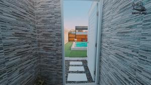 a door leading to a backyard with a swimming pool at Hotelru Koh Larn-โฮเต็ลรุ เกาะล้าน in Ko Lan