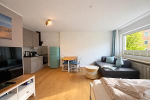 a living room with a couch and a table at Beachfront Studio - 1 Strandreihe in Scharbeutz