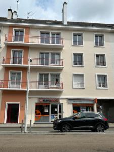 a black car parked in front of a building at ATLANTIS in Saint-Nazaire