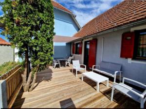 a wooden deck with benches and a tree at Terme Čatež - Family apartments with pool tickets in Čatež ob Savi