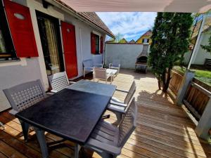 a patio with a table and chairs on a deck at Terme Čatež - Family apartments with pool tickets in Čatež ob Savi