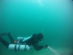 a scuba diver in the water with a camera at Hotel Karwendelblick in Urfeld