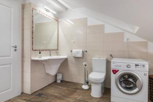 a bathroom with a toilet sink and a washing machine at Penthouse Matkovic in Split +32 photos