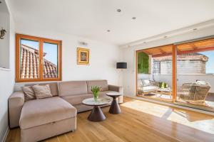 a living room with a couch and a table at Penthouse Matkovic in Split