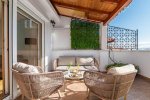 a patio with rattan chairs and a table at Penthouse Matkovic in Split
