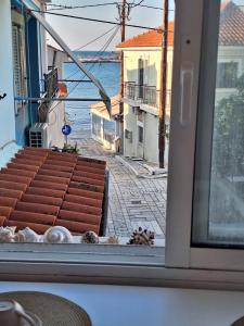 a view from a window of a street and the ocean at Perla in Pythagoreio