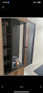 a bathroom with a mirror and a black cabinet at Likefront Apartment Issyk-Kul in Bosteri
