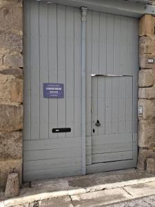 a pair of garage doors with a sign on it at La Maison Carolane in Latour-de-Carol +17 photos