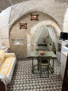 a room with a table and a room with a bed at Casa Doria in Fasano