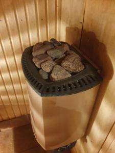 a trash can with rocks inside of it at Cosy VILLA with sauna in Saulkrasti +18 photos