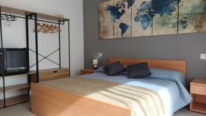 a bedroom with a bed and a map on the wall at Oris in Oristano