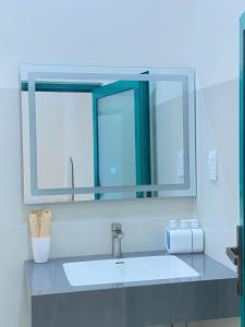 a bathroom sink with a large mirror above it at LANBA Homestay in Phan Rang–Tháp Chàm +41 photos