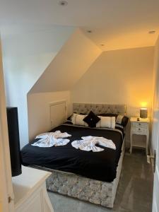 a bedroom with a large bed with clothes on it at Flat 2 Meadow view in Hurst