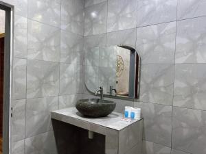 a bathroom with a sink and a mirror at Sayang Bungalows in Kuta Lombok
