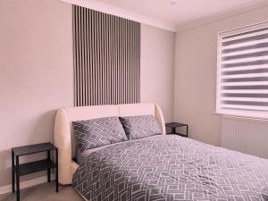 a bedroom with a bed and two end tables at Wildoaks in Northwood