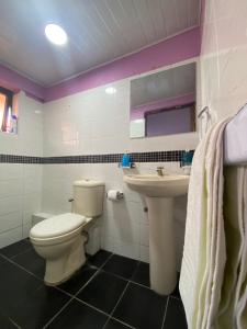 a bathroom with a toilet and a sink at Twendzetu kilifi in Kilifi