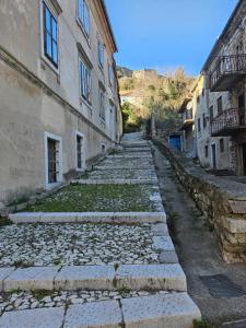 a cobblestone street in an alley between two buildings at Fortica inn in Knin