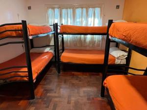a group of bunk beds in a room at Hostel Lagares in Mendoza