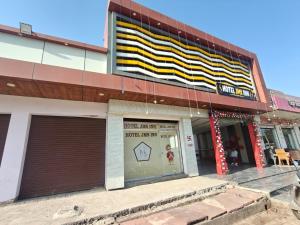 a building with a sign on the side of it at Hotel Jms Inn in Agra