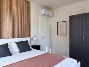 a bedroom with a bed and a tv on the wall at Tra i gussi in Imperia +10 photos