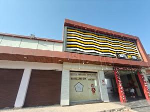 a building with a sign on the side of it at Hotel Jms Inn in Agra
