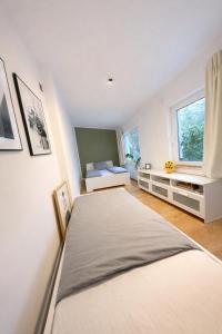 a bedroom with two beds and a window at MiniLoft Andernach in Andernach