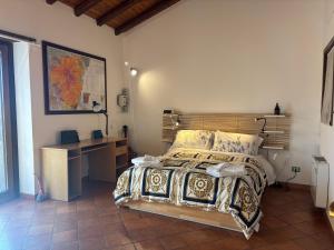 a bedroom with a bed and a desk in it at Soffio dell'Etna in Puntalazzo