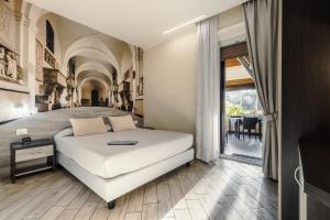 a bedroom with a large white bed and a table at 4 Rent di Cicchinelli Lorella in Albano Laziale