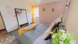 a bedroom with a bed with a yellow napkin on it at TOP HOST Les Perles des châteaux in Mer