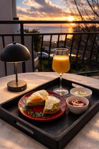 a tray with a sandwich and a glass of orange juice at Apartments Sabo in Kraljevica