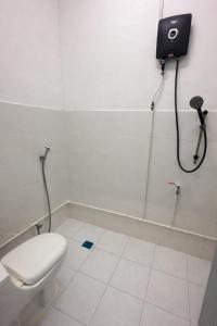a bathroom with a toilet and a shower at First Avenue Male Hostel BSB in Bandar Seri Begawan