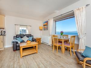 a living room with a couch and a table at Harbour View in Cromarty